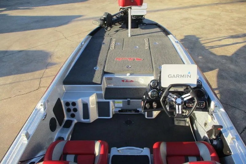 Slide: The Image of 2021 Bass Cat Cougar FTD boat interior with Garmin navigation system and red seats. - 2