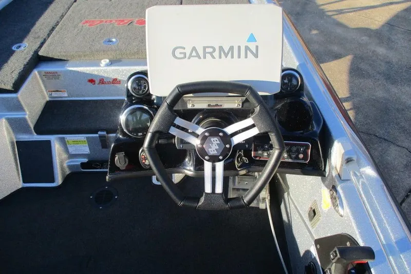 Slide: The Image of 2021 Bass Cat Cougar FTD boat dashboard with Garmin display and steering wheel. - 4