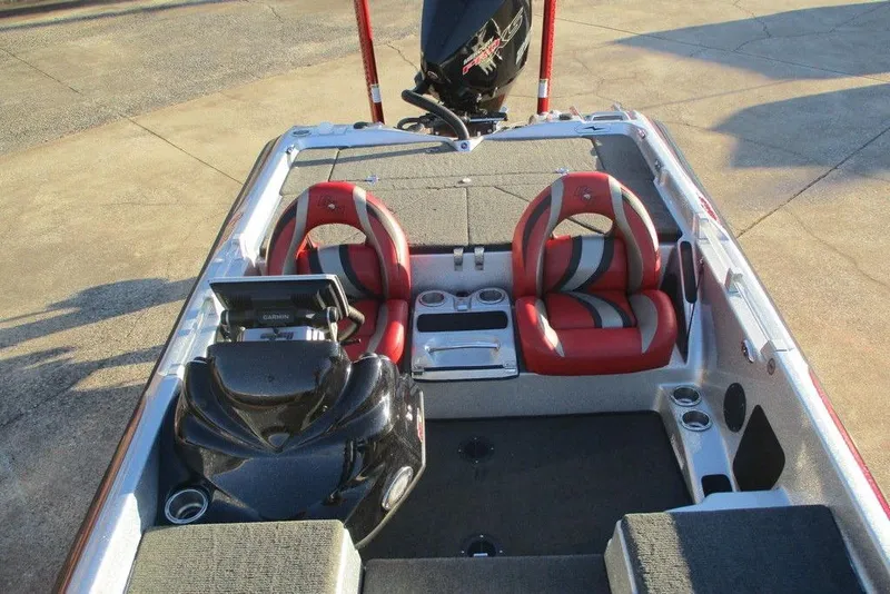 Slide: The Image of 2021 Bass Cat Cougar FTD boat interior with red seats and modern dashboard. - 5