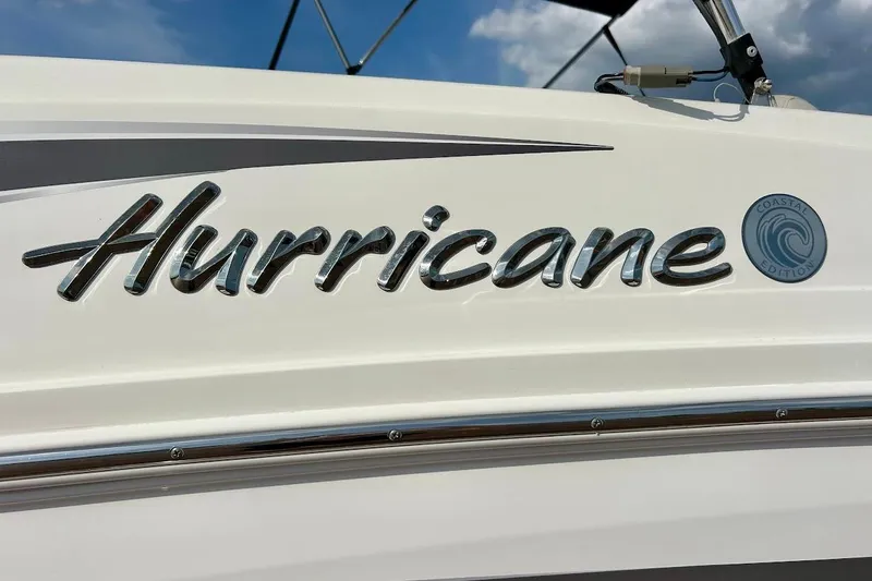 Slide: The Image of 2024 Hurricane Kayaks SS 218, Coastal Edition logo on white surface under blue sky. - 10