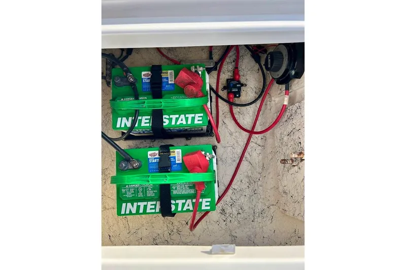Slide: The Image of Two Interstate batteries installed in a 2024 Hurricane Kayaks SS 218, with red and black cables. - 33