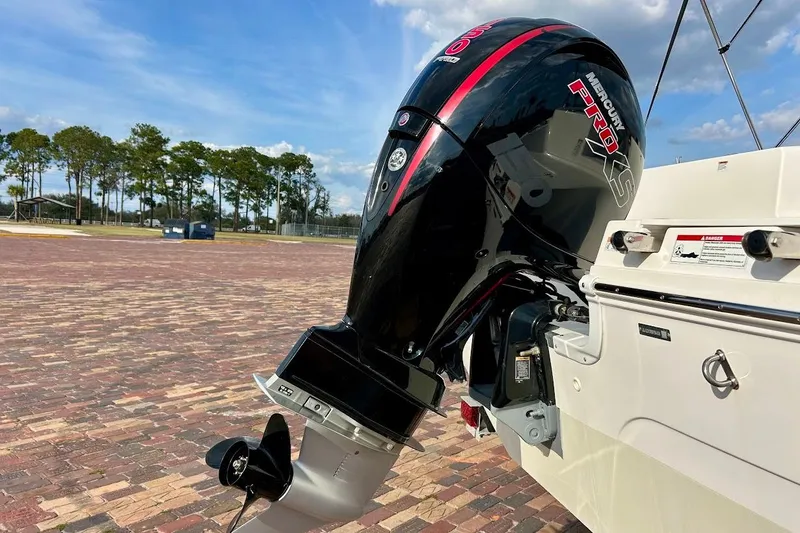 Slide: The Image of 2024 Hurricane Kayaks SS 218 with Mercury Pro XS outboard motor on brick pavement. - 8
