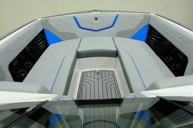 Slide: The Image of 2023 Nautique G23 interior with gray and blue upholstery. - 13