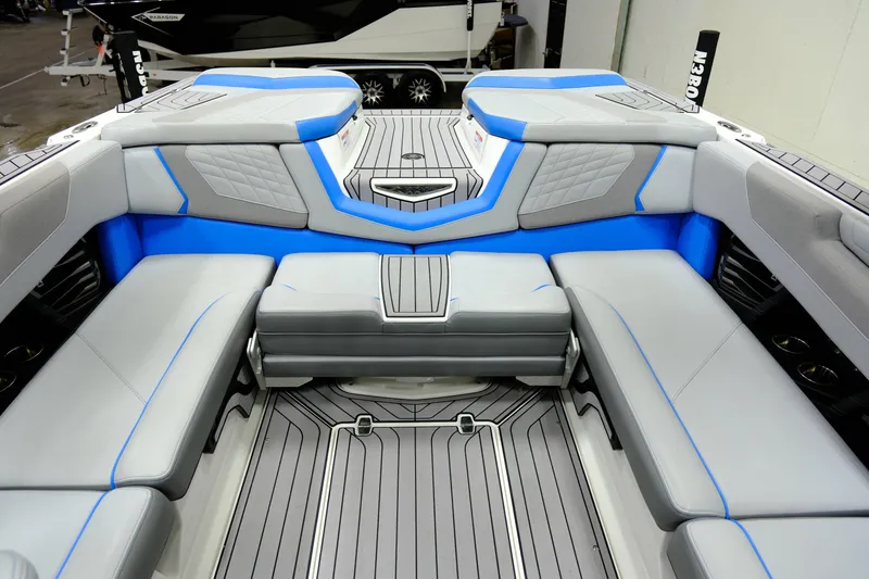 Slide: The Image of Interior of 2023 Nautique G23 boat with blue and gray seating. - 15