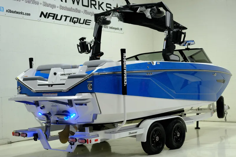 Slide: The Image of 2023 Nautique G23 boat in vibrant blue on trailer. - 3