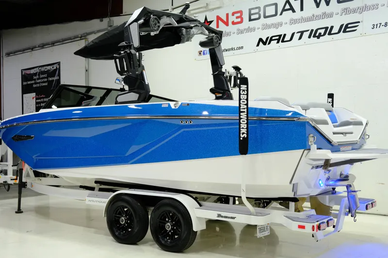 Slide: The Image of 2023 Nautique G23 boat in a workshop on a trailer. - 7
