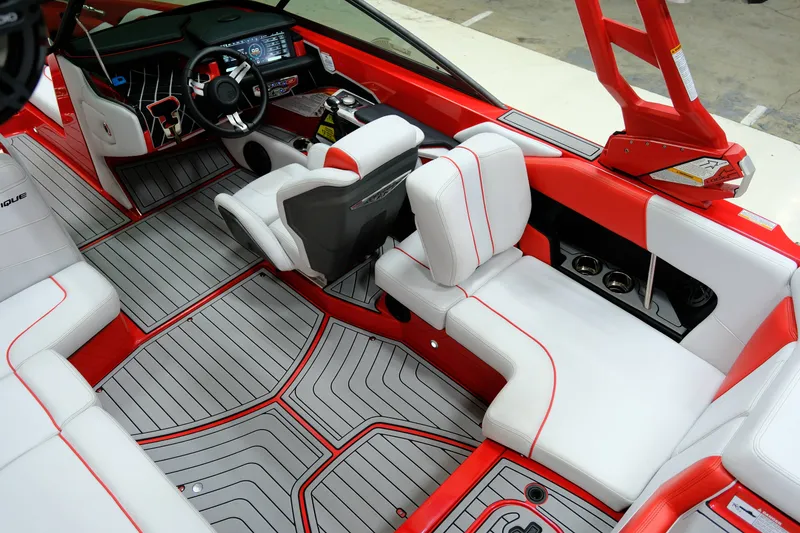 Slide: The Image of Interior of a 2018 Nautique 210 boat with red and white seating. - 11