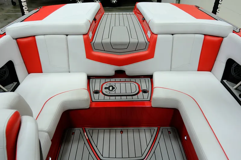 Slide: The Image of Interior of a 2018 Nautique 210 boat with red and gray seating. - 12