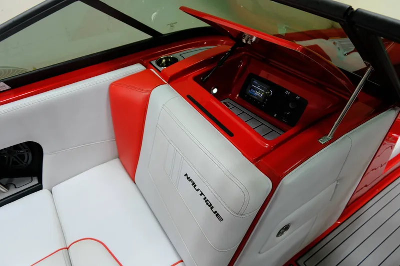 Slide: The Image of Interior of a 2018 Nautique 210 boat with red and white seating. - 13