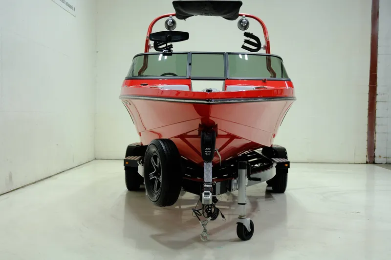 Slide: The Image of Red 2018 Nautique 210 boat on trailer in garage. - 4