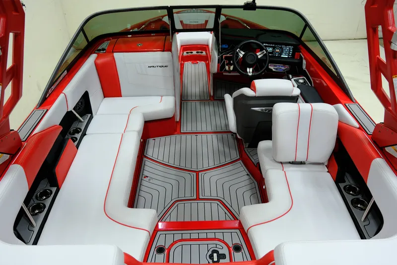 Slide: The Image of Interior of a 2018 Nautique 210 boat with red and white seating. - 9