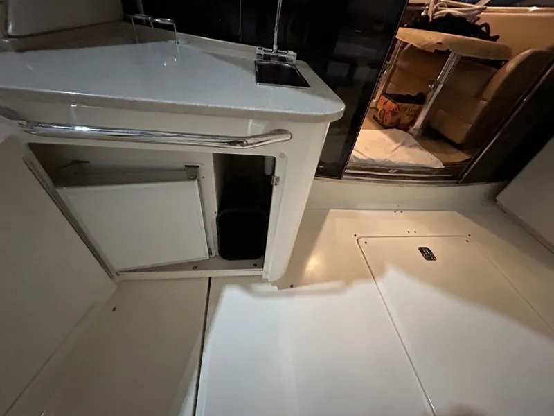 Slide: The Image of Interior of 2010 Sea Ray 610 Sundancer with storage and seating area. - 12