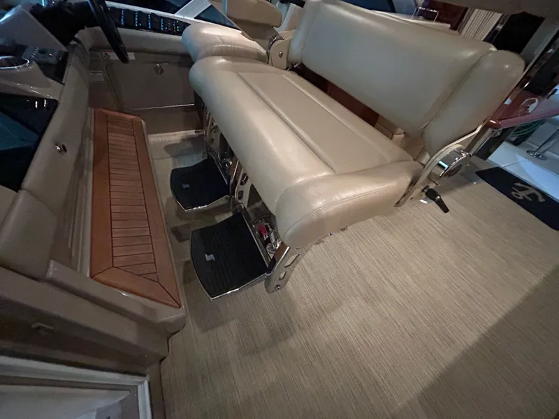 Slide: The Image of Interior of 2010 Sea Ray 610 Sundancer with beige leather seat. - 25