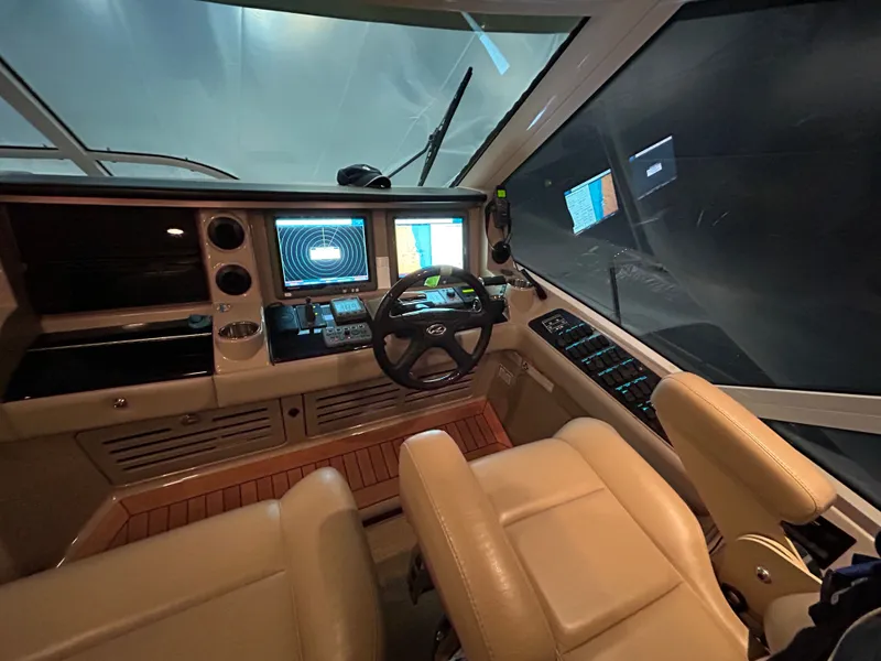 Slide: The Image of Interior of 2010 Sea Ray 610 Sundancer with modern helm console. - 26