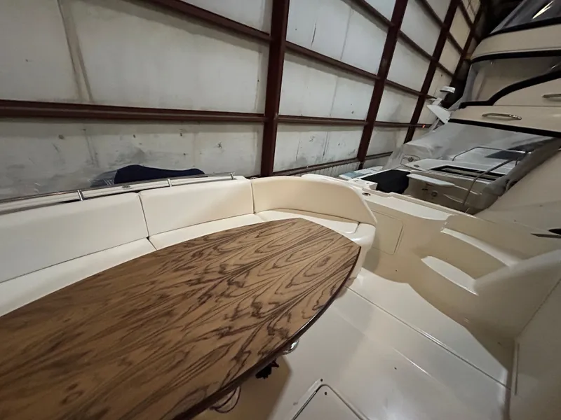 Slide: The Image of Interior of 2010 Sea Ray 610 Sundancer with wooden table. - 8