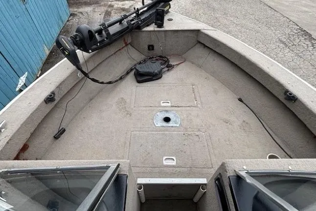 Slide: The Image of 2003 Monark King 190 boat interior with open deck and mounted equipment. - 10