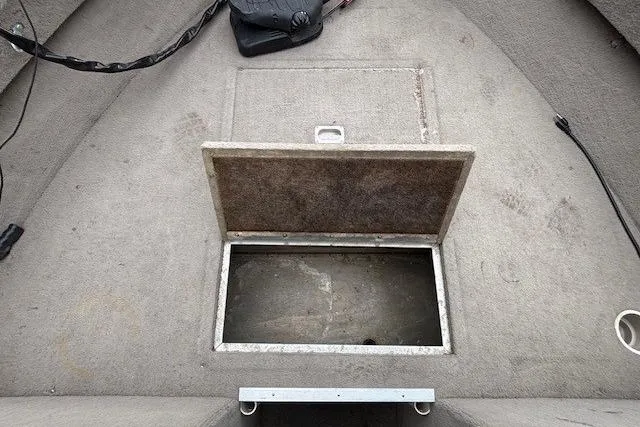 Slide: The Image of Open storage compartment on a 2003 Monark King 190 boat deck. - 13