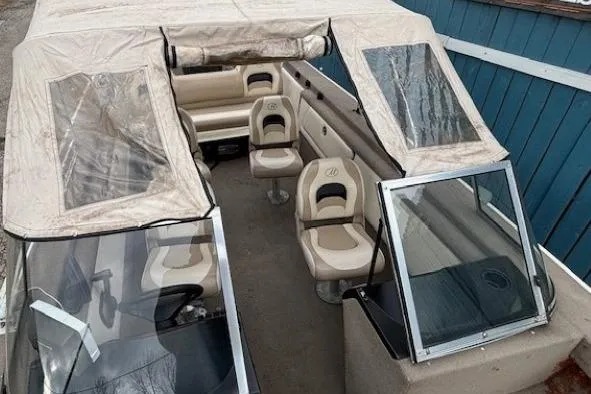 Slide: The Image of 2003 Monark King 190 boat interior with beige seating and canopy. - 14