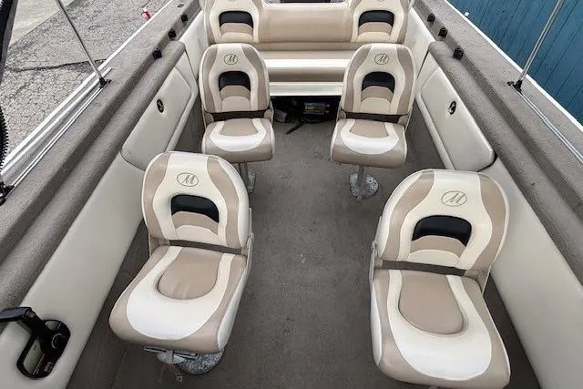 Slide: The Image of 2003 Monark King 190 boat interior with beige and white seating arrangement. - 15