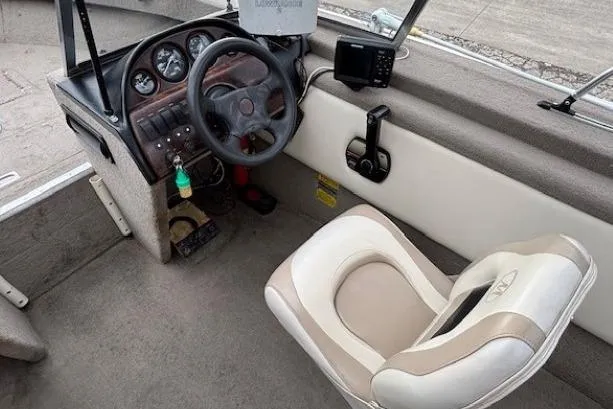 Slide: The Image of Interior of a 2003 Monark King 190 boat showing steering console and seat. - 17