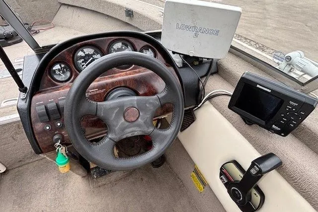 Slide: The Image of Steering console of a 2003 Monark King 190 boat with Lowrance electronics. - 18