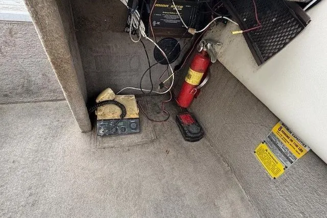 Slide: The Image of Interior of a 2003 Monark King 190 boat with fire extinguisher and wiring. - 19