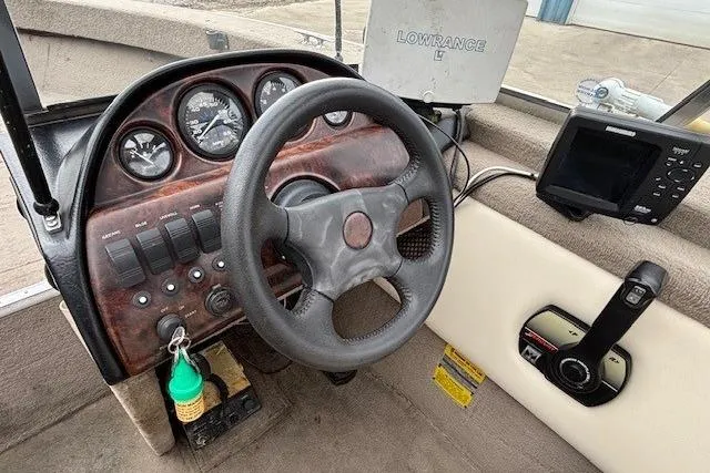 Slide: The Image of Steering console of a 2003 Monark King 190 boat with gauges and navigation equipment. - 21