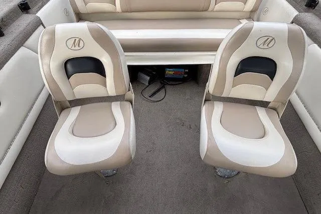 Slide: The Image of Two beige and white boat seats in a 2003 Monark King 190. - 25