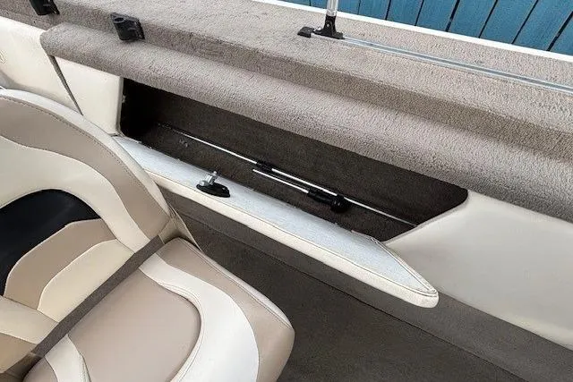 Slide: The Image of Interior of 2003 Monark King 190 boat with storage compartment and beige seating. - 26