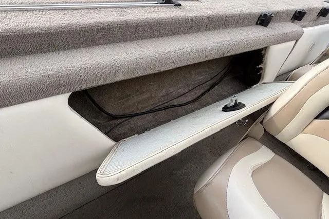 Slide: The Image of Interior of a 2003 Monark King 190 boat showing open storage compartment and seating. - 27