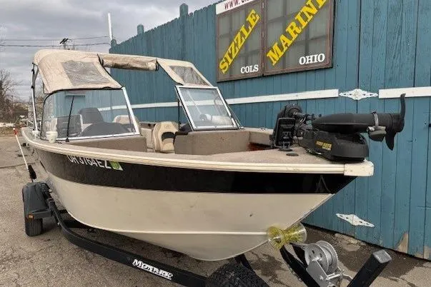 Slide: The Image of 2003 Monark King 190 boat on trailer, parked outside Sizzle Marine, Ohio. - 3