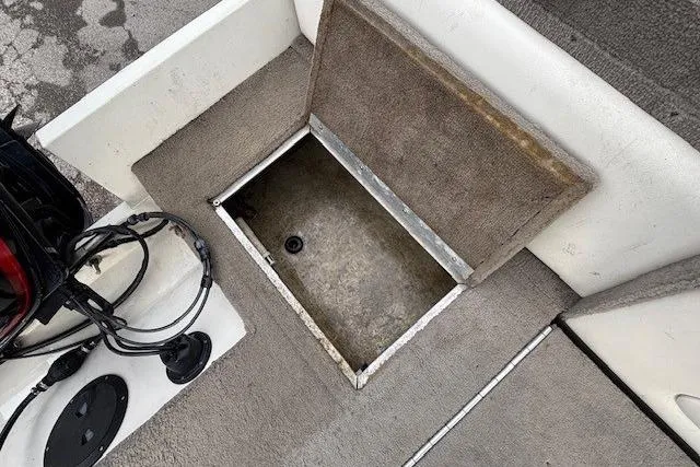 Slide: The Image of Open storage compartment on 2003 Monark King 190 boat deck. - 32