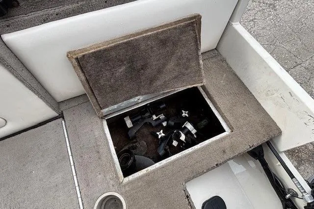 Slide: The Image of Storage compartment in a 2003 Monark King 190 boat, containing various equipment. - 33