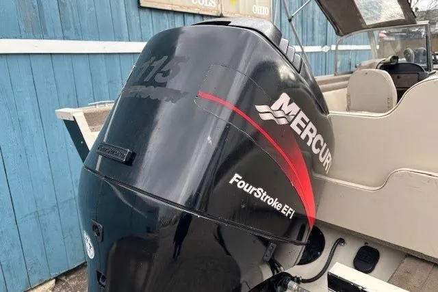 Slide: The Image of Outboard motor on a 2003 Monark King 190 boat, featuring Mercury FourStroke EFI. - 34