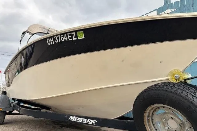 Slide: The Image of 2003 Monark King 190 boat on trailer, side view with registration number visible. - 4