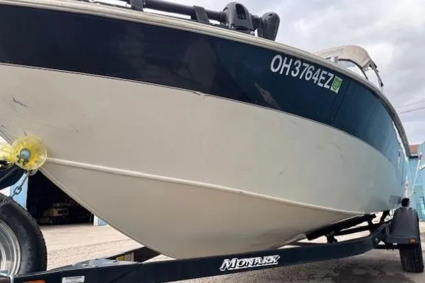 Slide: The Image of 2003 Monark King 190 boat on trailer, side view with registration number visible. - 5