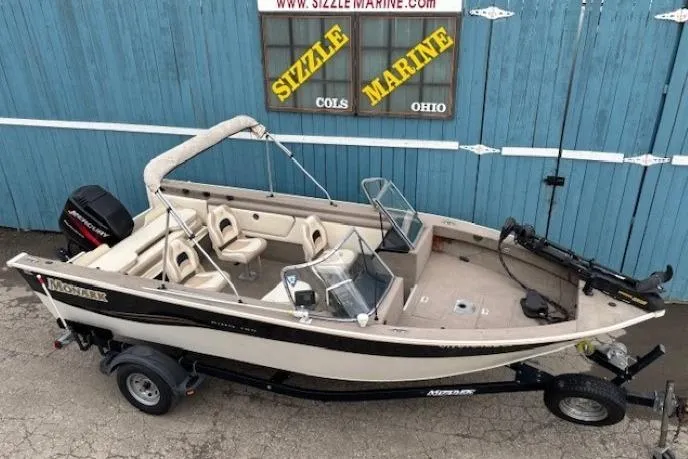 Slide: The Image of 2003 Monark King 190 boat with trailer, parked outside Sizzle Marine, Ohio. - 8