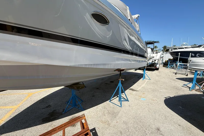 Slide: The Image of 2014 Formula 290 Sun Sport boat on stands in a marina under clear blue sky. - 10