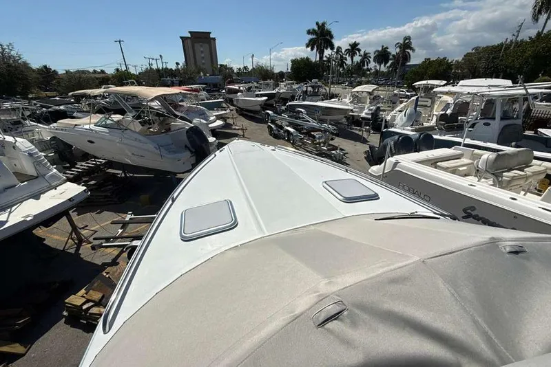 Slide: The Image of 2014 Formula 290 Sun Sport boat in a marina with multiple vessels. - 11