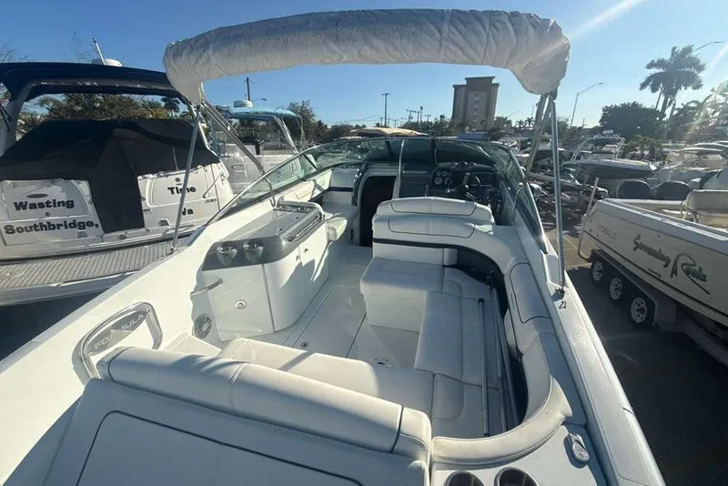 Slide: The Image of 2014 Formula 290 Sun Sport boat with spacious seating and sleek design in marina setting. - 13