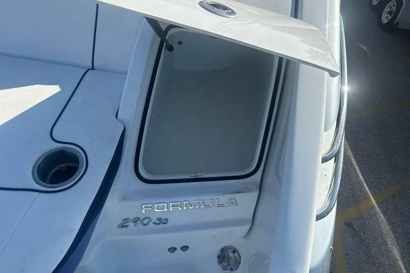 Slide: The Image of 2014 Formula 290 Sun Sport boat with open storage compartment, showcasing sleek design. - 14