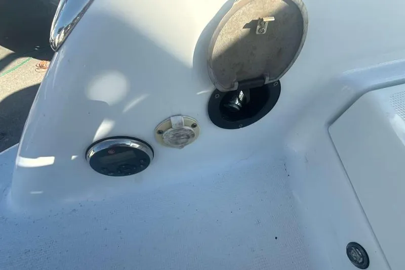 Slide: The Image of 2014 Formula 290 Sun Sport boat dashboard with open compartment and controls. - 16