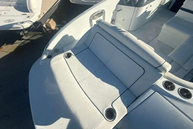 Slide: The Image of 2014 Formula 290 Sun Sport boat interior with white seating and cup holders. - 20