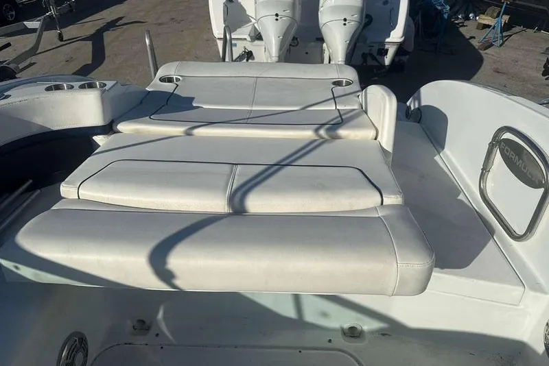 Slide: The Image of 2014 Formula 290 Sun Sport boat interior with cushioned seating and cup holders. - 21