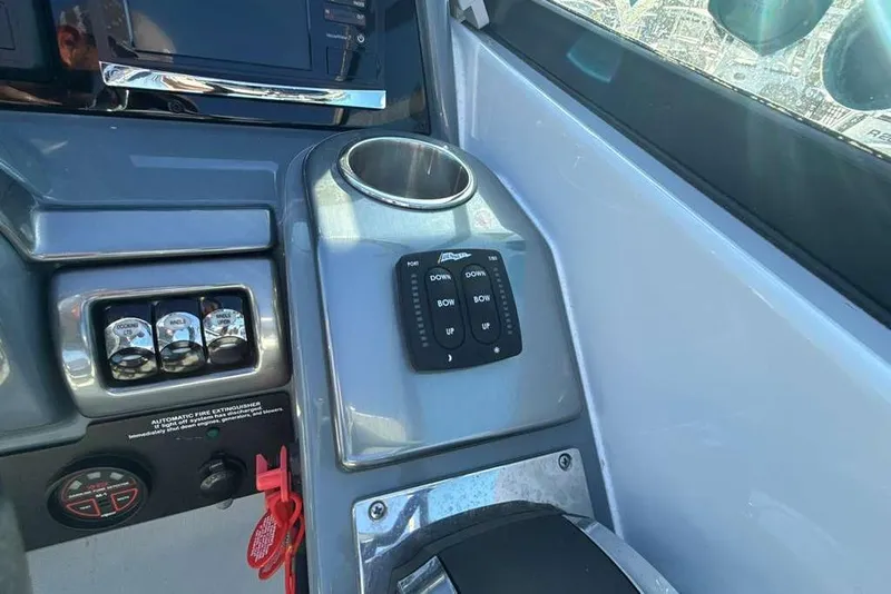 Slide: The Image of Control panel of 2014 Formula 290 Sun Sport boat with switches and cup holder. - 28