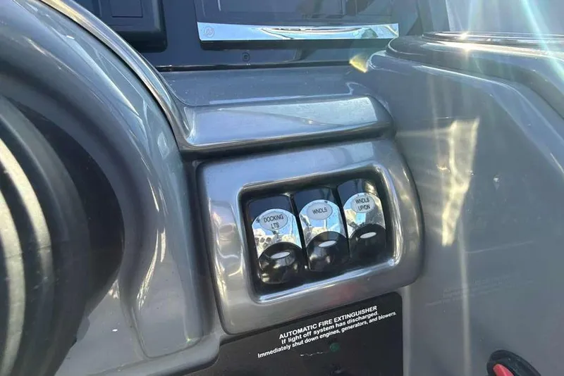 Slide: The Image of Dashboard controls of a 2014 Formula 290 Sun Sport boat, featuring switches and labels. - 30