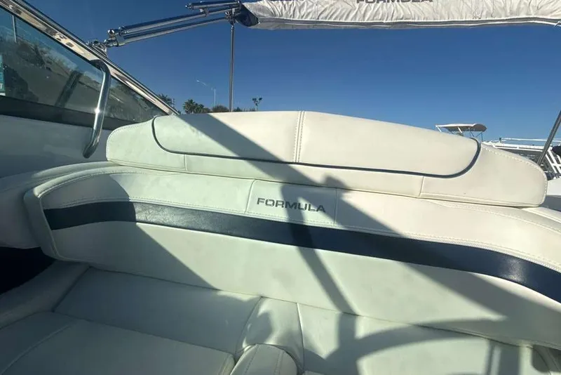 Slide: The Image of 2014 Formula 290 Sun Sport boat interior with white leather seating and blue accents. - 31