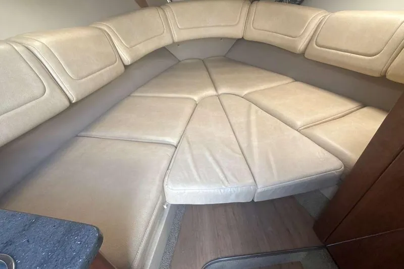 Slide: The Image of 2014 Formula 290 Sun Sport cabin interior with beige seating and wooden accents. - 35