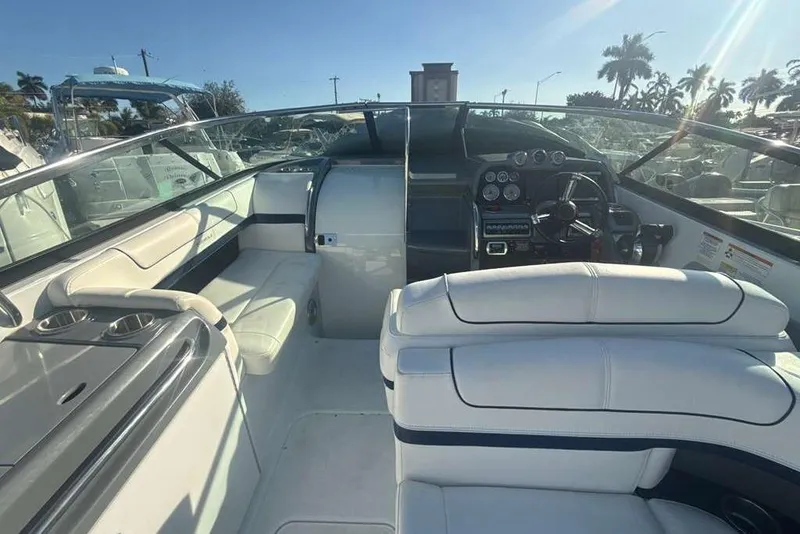 Slide: The Image of 2014 Formula 290 Sun Sport boat interior with white seating and control panel. - 36