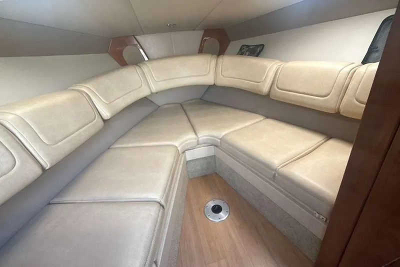 Slide: The Image of 2014 Formula 290 Sun Sport cabin interior with beige seating and wood flooring. - 39
